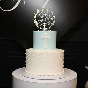 a white cake with a blue and white cake topper