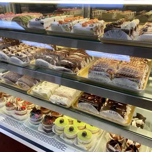 a variety of pastries in a display case