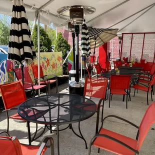 tables and chairs with umbrellas