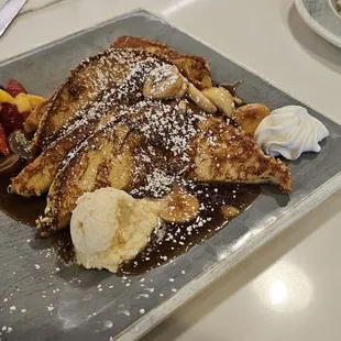 2 French Toast 9.5 Two slices of Brioche French toast, cinnamon powdered sugar, syrup, honey butter . Add Bananas Foster sauce 3