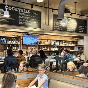 people sitting at tables in a restaurant