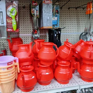 a variety of red pots and pans