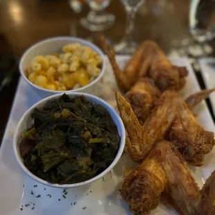 Fried chicken wings with collard greens and Mac and cheese.