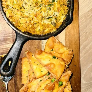 a skillet of food on a cutting board