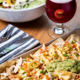 a plate of nachos and a glass of beer