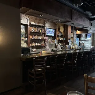 a bar with a long counter and bar stools