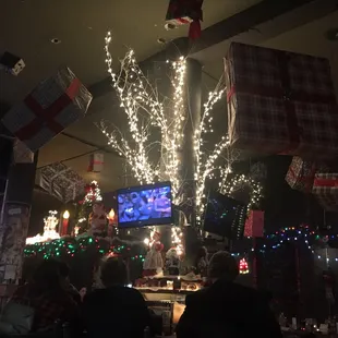 a christmas tree decorated with lights and stockings