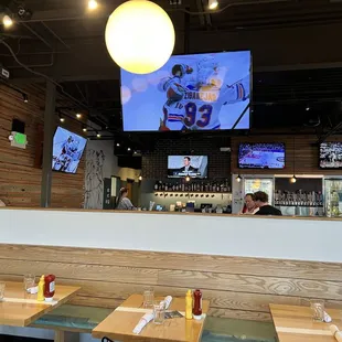 a restaurant with a bar and televisions