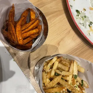 a plate of fries and a bowl of salad