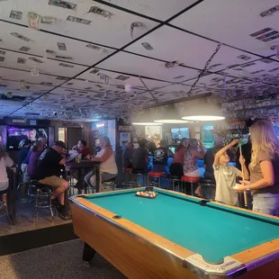 a pool table in the middle of the room