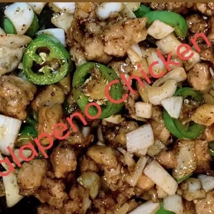 a closeup of a stir fry with onions and jalapenos