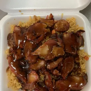 a takeout container of chicken and rice