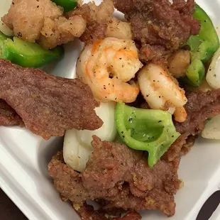 steak, shrimp, and vegetables in a styrofoam container