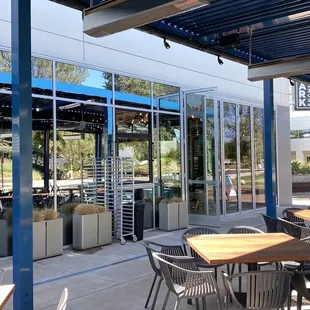 a patio with tables and chairs