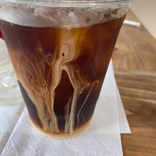 a glass of iced coffee on a napkin