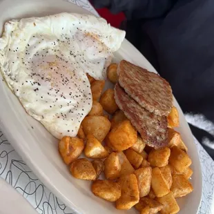 a plate of eggs, sausage and potatoes