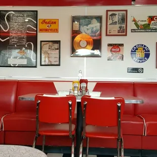 50's ads on the wall, leather covered seats, formica table tops, black and white square tiles, 50's music playing overhead