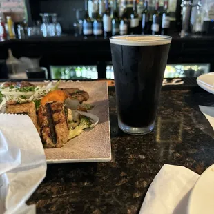 a plate of food and a glass of beer