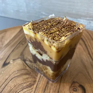 a dessert in a glass on a wooden table