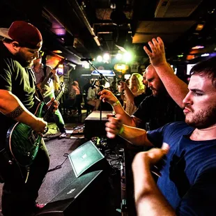 a group of people playing music in a bar