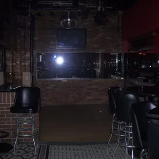 a bar with black leather chairs
