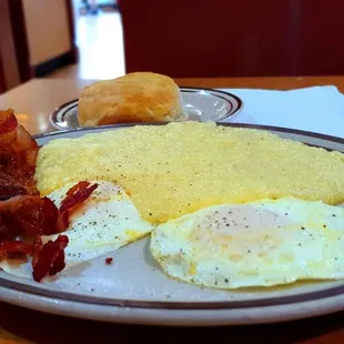 eggs, bacon, and biscuits on a plate
