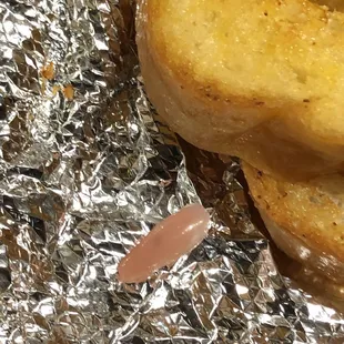 a close up of a doughnut on a piece of tin foil