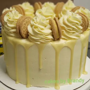a cake with cream frosting and cookies on top