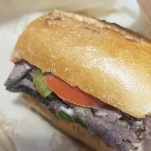 SF Philly Deli Sandwich-Lightly toasted sourdough roll, warm roast beef with melted provolone and the works.