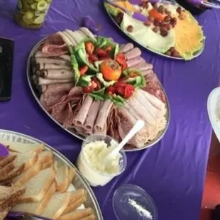 Purple Party! Design your own sandwich tray. Bread, meat, and cheese tray. Severed with side of lettuce, tomatoes, and pickles.