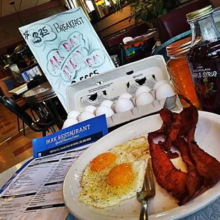 eggs, bacon, and jam on a plate