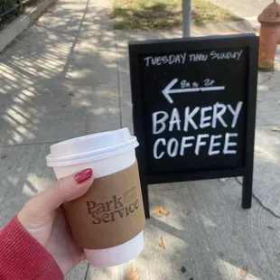 a hand holding a cup of coffee