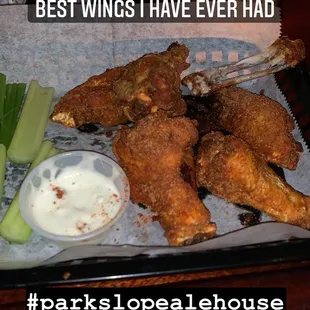 a tray of fried wings and celery