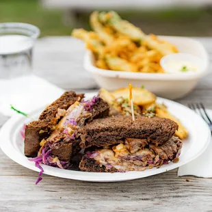 The Park Station Sandwich - corned beef, sweet and sour cabbage, Swiss cheese, thousand island dressing on dark rye bread, garlic fries