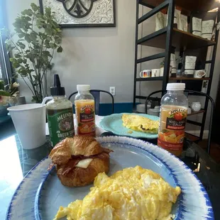 Croissant bacon sandwich egg on the side and bacon omelet