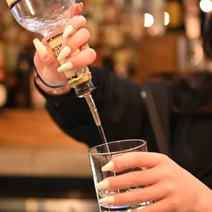 a bartender pouring a drink