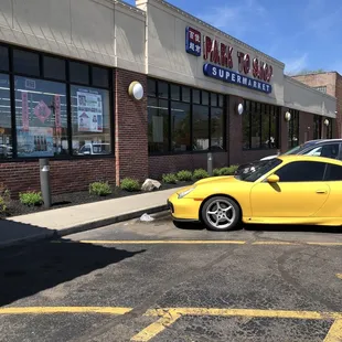 a yellow sports car parked in a parking lot