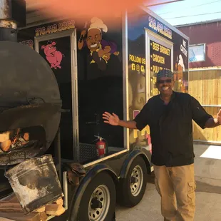 a man standing in front of a bbq