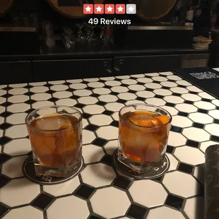 two glasses of whiskey on a table