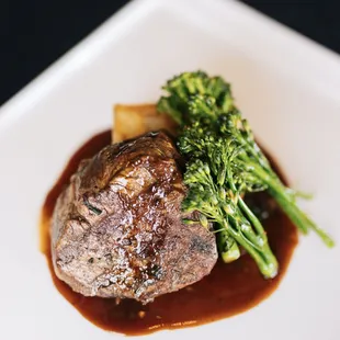 a steak and broccoli on a plate