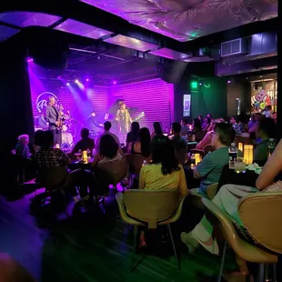 a crowd of people sitting at tables