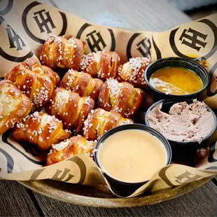 a basket of pretzels and dips