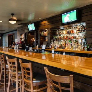 a bar with wooden bar stools