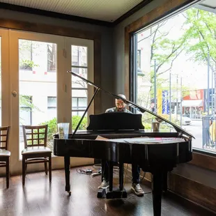 a man playing a grand piano