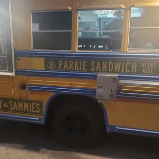 the side of a yellow and blue bus