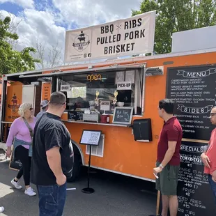 people ordering food from a food truck