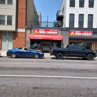 two cars parked in front of a restaurant