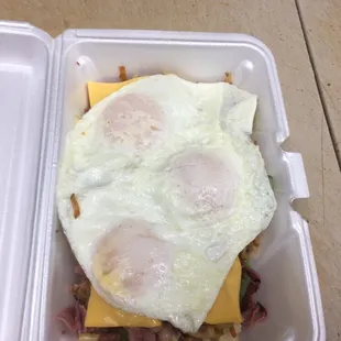 Cornbeef hash green peppers,onion ,hash brown,Cornbeef topped with two eggs of your choice add cheese for 55 cent a slice