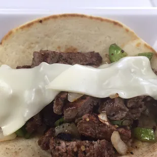 New York steak pita,8oz steak strip cooked to perfection topped with greenpepper,onion,Swiss
