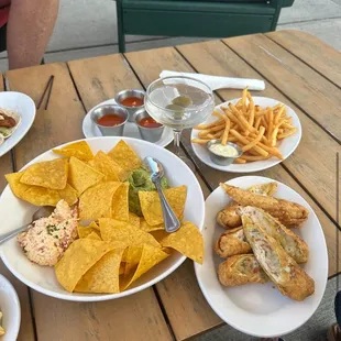 empandas, egg rolls, pimento cheese and guacamole dip, fries, and dirty martini